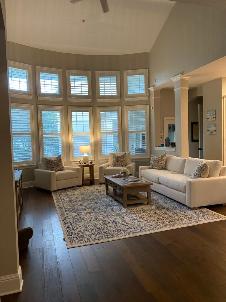Living room with dark hardwood flooring and tall windows