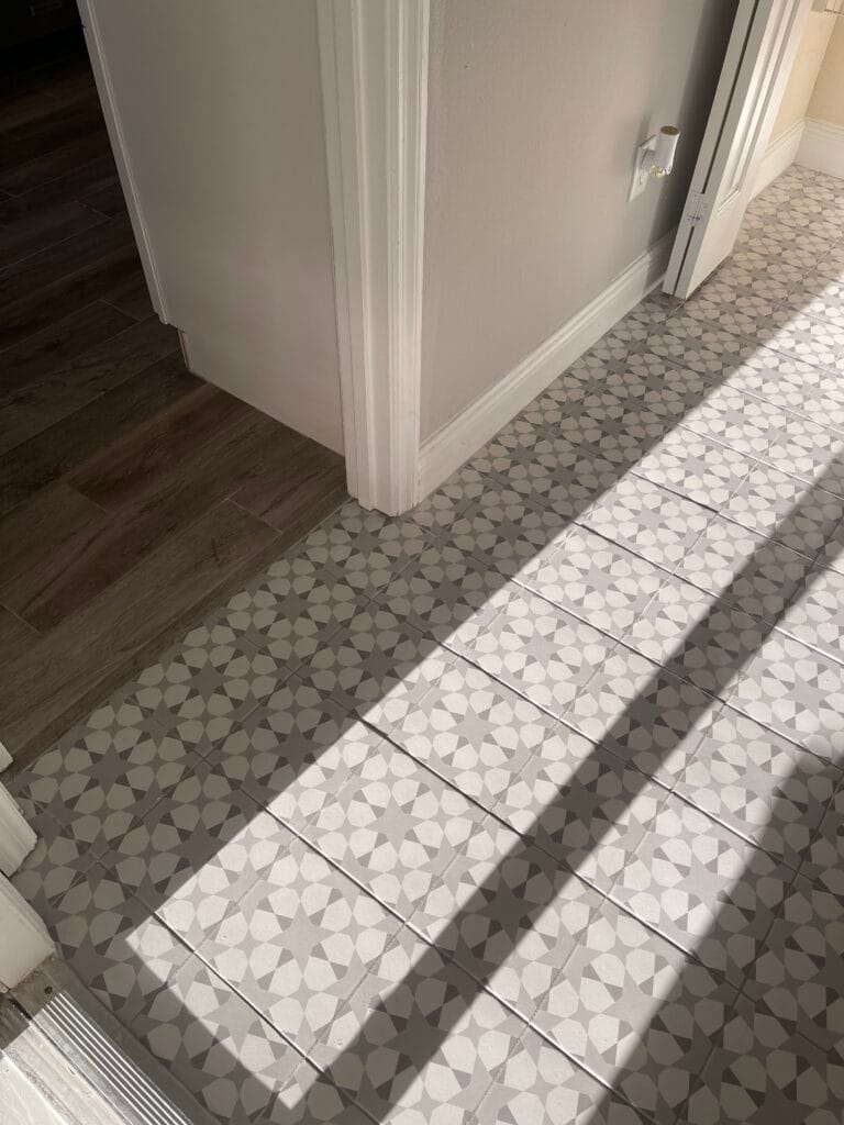 Patterned gray and white tile in a hallway