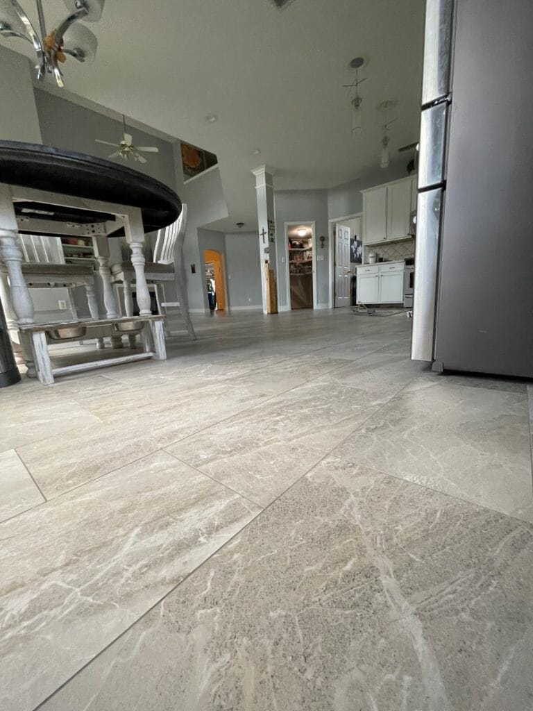 Gray tile floor in a kitchen with bar stools