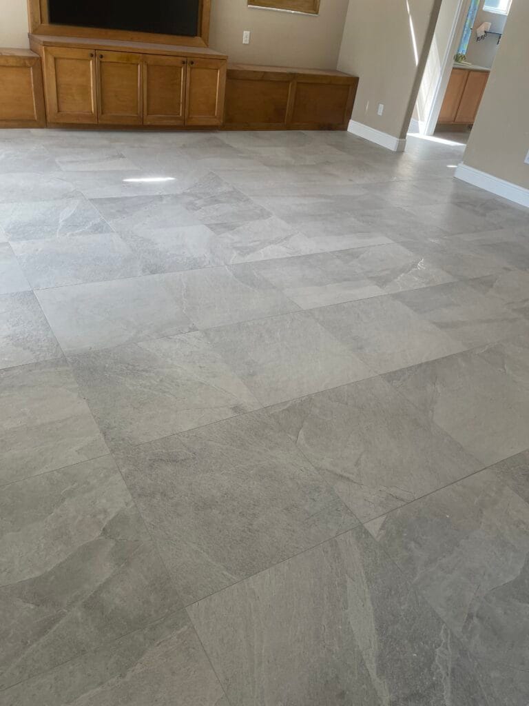 Gray tile floor in a living area beside the kitchen