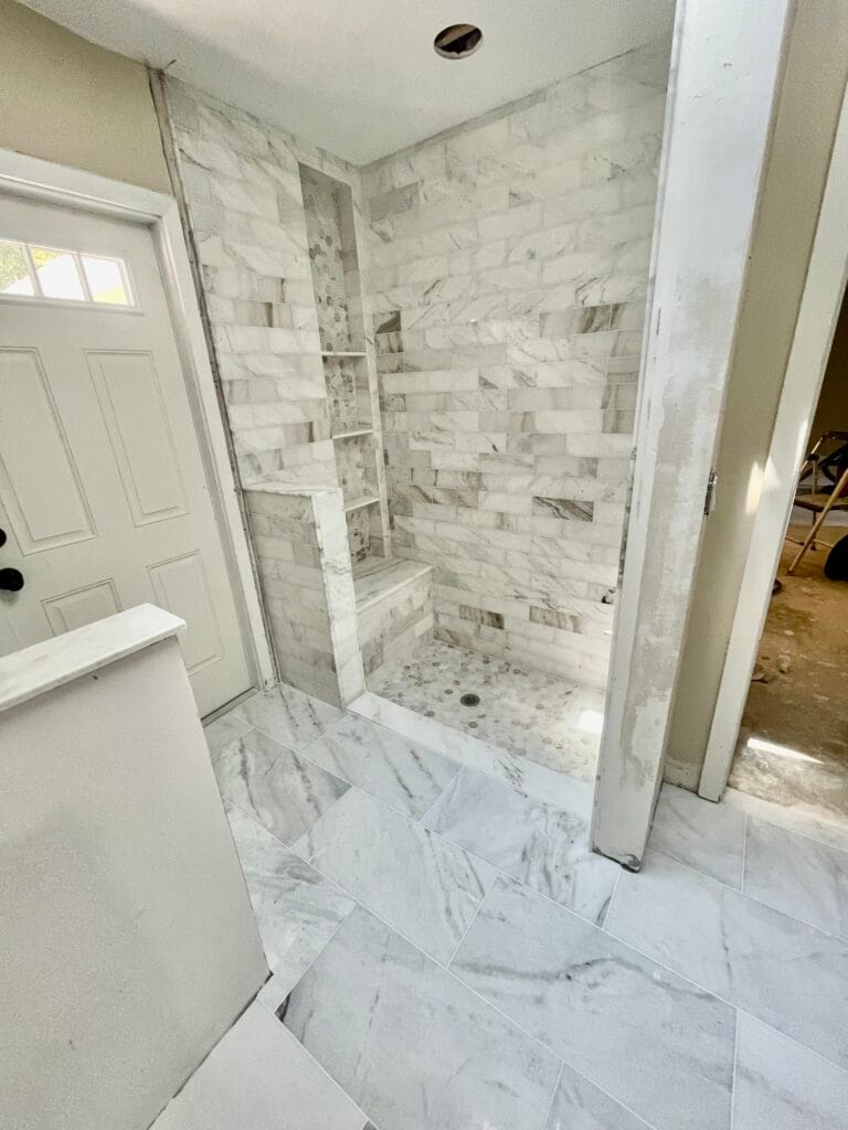 Marble-look tile shower and bathroom floor