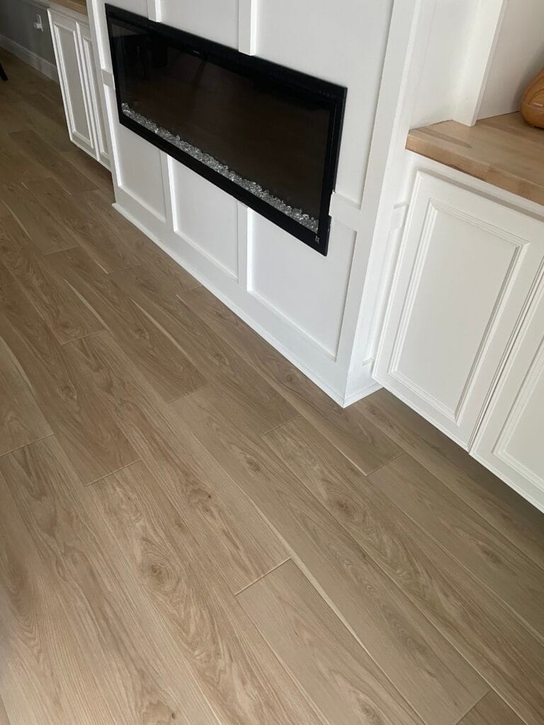 Wood-look flooring in a living room with built-in fireplace